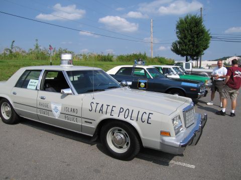 1991 Ford Crown Victoria - Several police cars are lined up, with the closest one being a Rhode Island State Police vehicle.