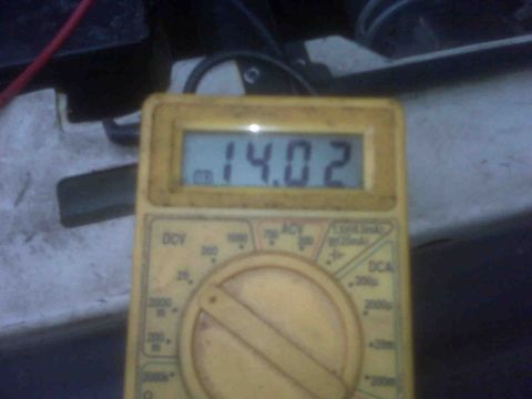 1995 Ford Bronco - Digital multimeter displays 14.02 volts, likely measuring battery charge.