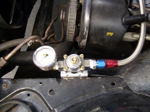 1972 Ford Ranchero - Close-up of a fuel pressure regulator and gauge assembly with braided fuel lines.