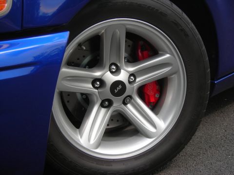 2007 Ford Mustang - SVT wheel and red brake caliper detail on a blue Ford Mustang.