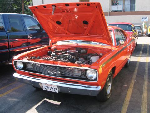 1990 Ford Bronco - orange compact muscle car sits with its hood raised showing the engine, California plate 3RPT833, at a car show.