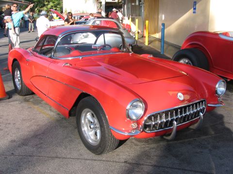 1990 Ford Bronco - red first-generation Chevrolet Corvette with its toothy chrome grille and hardtop parked at a car show.
