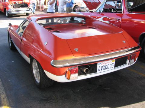 1990 Ford Bronco - rear three-quarter view of a red Lotus Europa showing its tall buttress pillars and California plate 4VXK035.