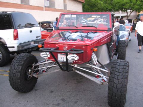 1990 Ford Bronco - red custom tube-chassis Volkswagen-bodied buggy with exposed front suspension and large tires, parked on a street.