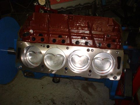 1968 Ford Galaxie - Engine block with pistons visible, set up on a stand for assembly or testing.