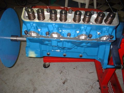 1968 Ford Galaxie - A blue engine block is mounted on a red stand, ready for assembly or inspection.