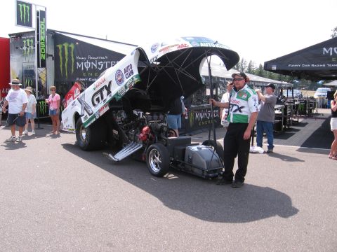 1998 GMC Sierra 1500 - A drag racing funny car is shown with its body lifted, revealing the engine and chassis components.