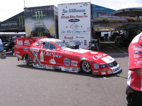 1998 GMC Sierra 1500 - A red funny car drag racer with "Old Spice" branding is parked on asphalt, with trailers in the background.