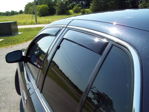 1999 Mercury Grand Marquis - The photo shows the side windows of a car with aftermarket vent shades installed.