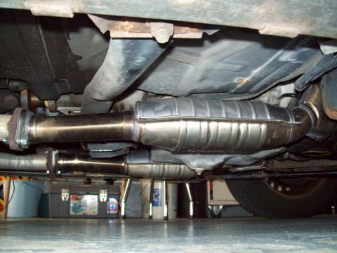 1999 Mercury Grand Marquis - Underside view of a car's exhaust system, showing catalytic converters and pipes.
