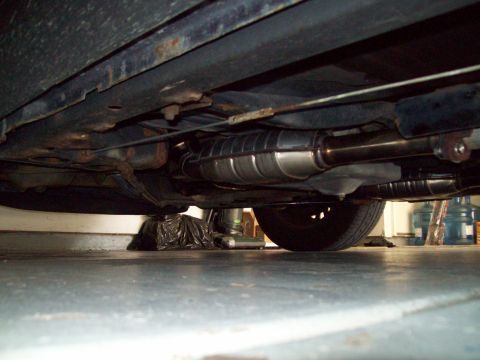 1999 Mercury Grand Marquis - The catalytic converter and exhaust system are visible from underneath the vehicle.