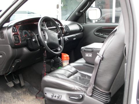 1990 Chevrolet Suburban - The interior of a truck is visible, leather seats, a dashboard with gauges, and a manual transmission shifter.