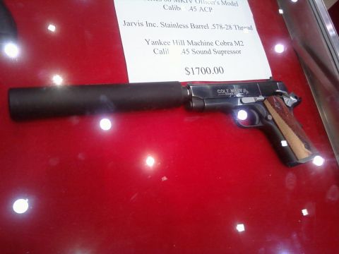 2000 Mercury Grand Marquis - A Colt M1911 pistol with a sound suppressor is displayed with a price tag of $1700.00.