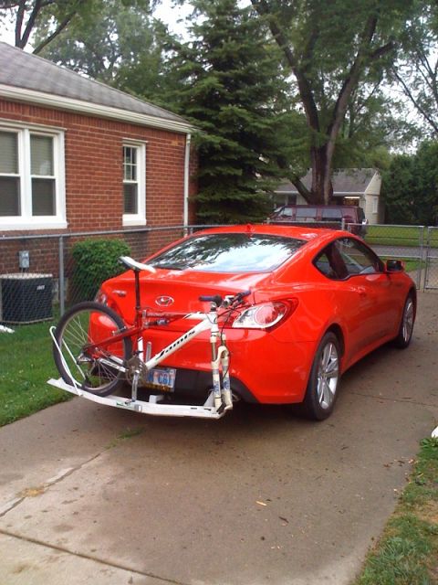 2010 Hyundai Genesis - Rear view of a red 2010 Hyundai Genesis coupe equipped with a bicycle rack carrying a bike.