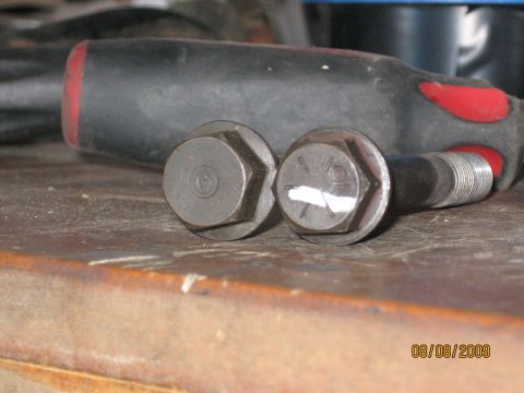 1994 Ford Bronco - Close-up of two bolts and a screwdriver on a workbench. The date 08/08/2009 is visible.