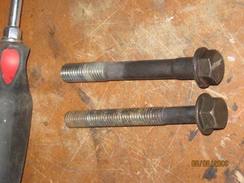 1994 Ford Bronco - A close-up shows two bolts and a screwdriver on a workbench. The date stamp indicates the photo was taken on August 8, 2009.