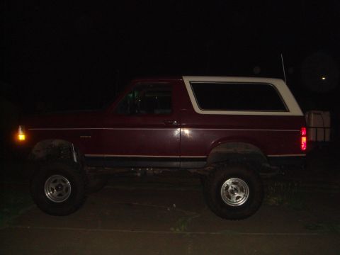 1992 Ford Bronco - This 1992 Ford Bronco is shown from the side, a two-tone red and white color scheme.