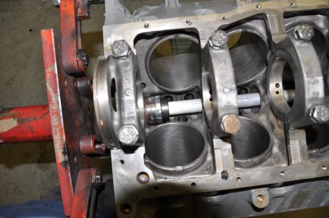 1996 Ford Bronco - Close-up view of an engine block during a cam installation, showing the crankshaft and connecting rods secured by bearing caps.