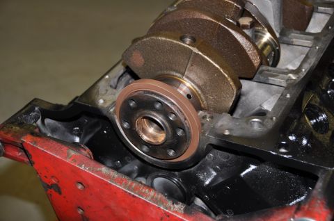 1996 Ford Bronco - Close-up view of an engine block a crankshaft and a front seal, likely during a repair or rebuild process.