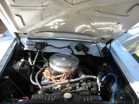 1969 Ford Ranchero - The engine bay of a classic vehicle, showing the V8 engine and associated components.