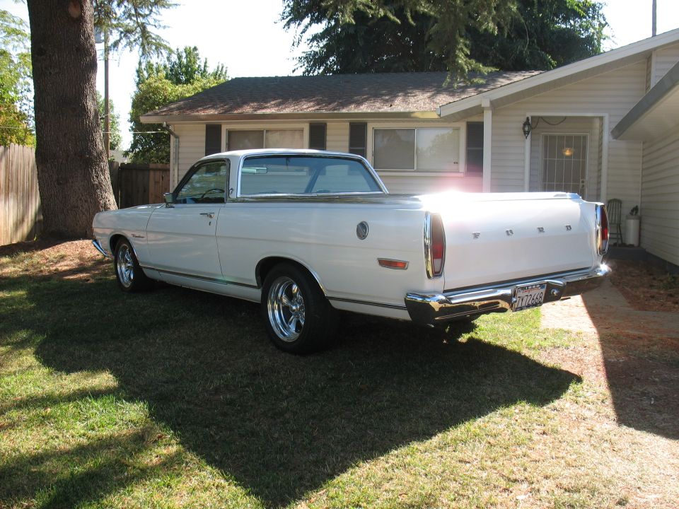 1969 Ford Ranchero parked on grass in front of a house