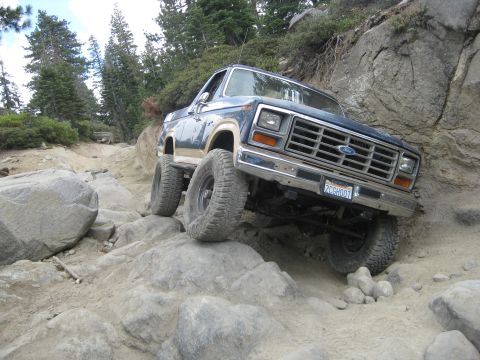 1986 Ford Bronco - This 1980s Ford Bronco tackles a challenging rocky terrain, its off-road capabilities.
