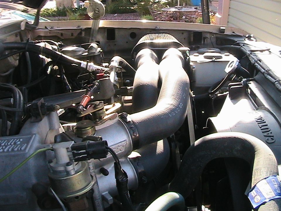 1985 Ford Bronco engine bay with air intake and hoses visible
