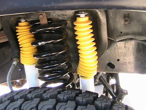 1985 Ford Bronco - A view of the front suspension system, including shocks and springs, on a vehicle.