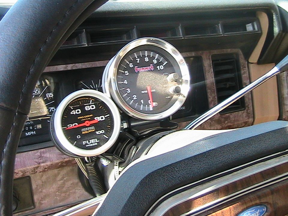 1985 Ford Bronco interior with Summit tachometer and Pro-Comp fuel pressure gauge mounted on steering column