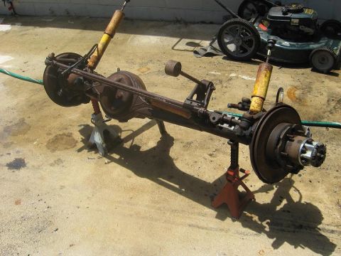 1987 Toyota 4Runner - A rear axle assembly, likely from a truck or SUV, is shown supported by jack stands on a concrete surface.