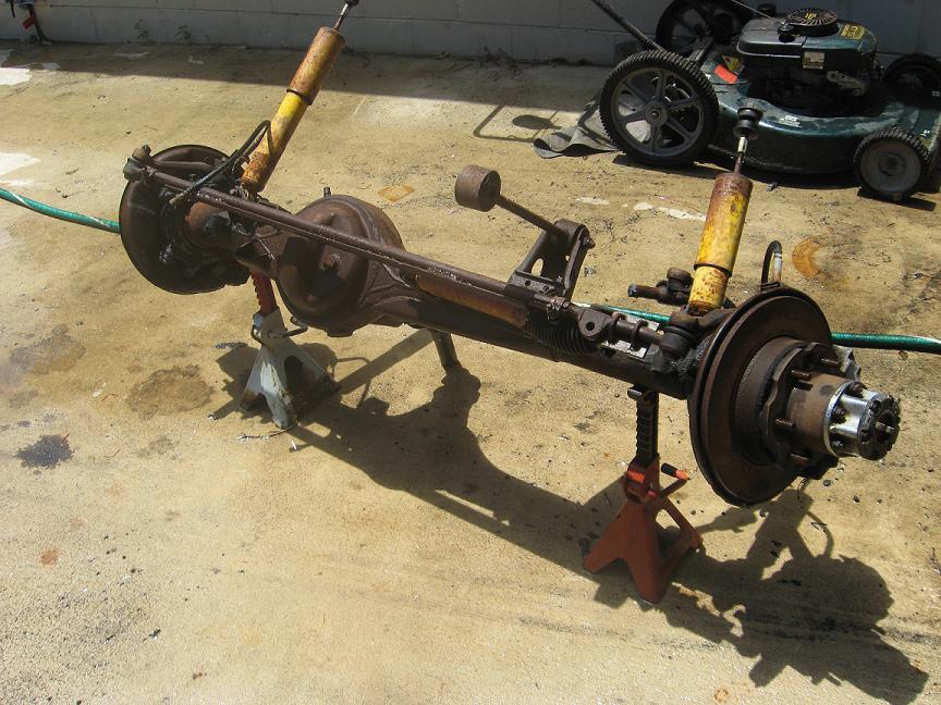 Rear axle assembly with yellow shocks on jack stands
