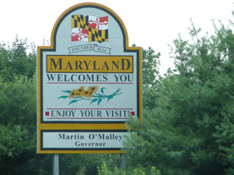 1992 Ford Taurus - A sign welcomes visitors to Maryland, the state flag and sunflowers, with the governor's name below.