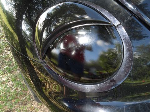 1999 Volkswagen Beetle - Close-up of the distinctive headlight on a 1999 Volkswagen Beetle.
