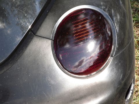 1999 Volkswagen Beetle - Taillight assembly on a gray car body.