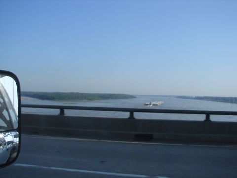 1992 Ford Taurus - Driving over a bridge with a view of barges on the river below.