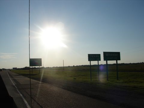 1992 Ford Taurus - Signs indicate the Texas State Line and Wheeler County as seen from a vehicle on a sunny day.