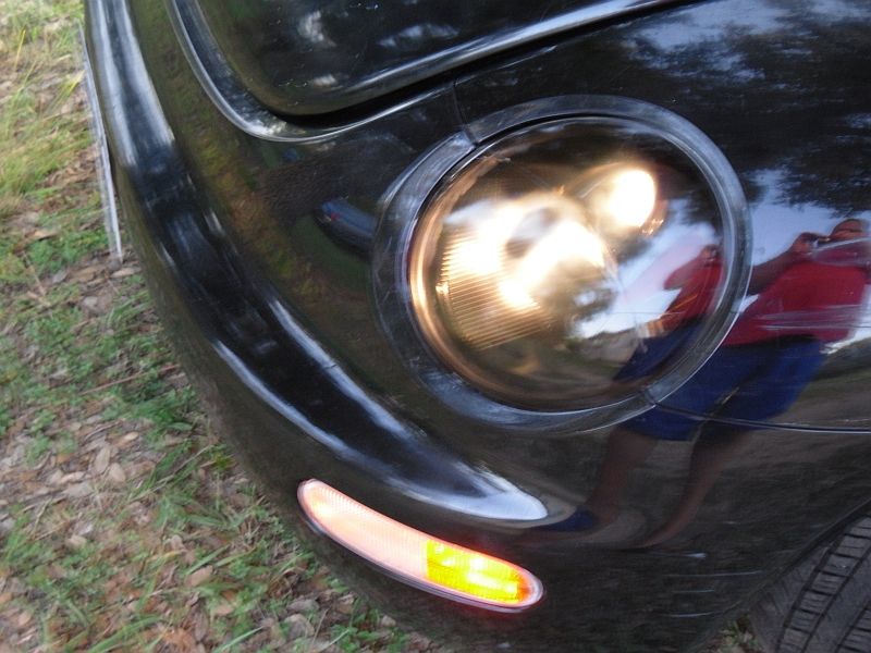 1999 Volkswagen Beetle front corner with headlight on and amber turn signal