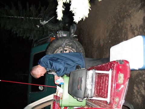 1991 Ford Bronco - Man loading gear into the back of a 1991 Ford Bronco during a nighttime trip.