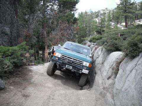 1991 Ford Bronco - Ford Bronco navigating a challenging rocky trail, with another vehicle following.