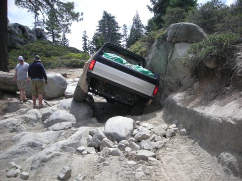 1991 Ford Bronco - A 1991 Ford Bronco tackles a challenging rocky trail, demonstrating its off-road capabilities.