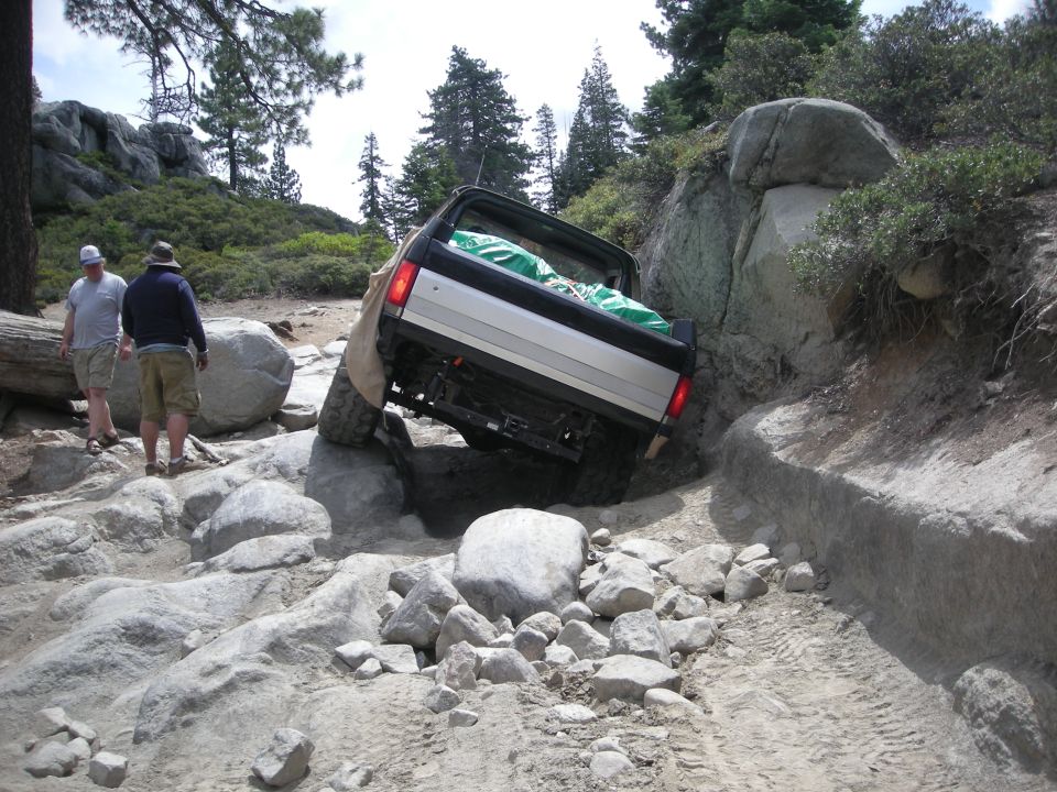 1991 Ford Bronco rear view navigating rocky terrain