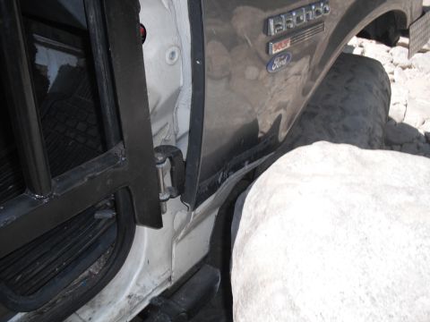 1991 Ford Bronco - Close-up of a 1991 Ford Bronco's side, showing the door jamb and fender detail.