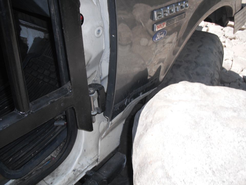 1991 Ford Bronco door jamb and fender with 'Eddie Bauer' badging, off-road tire visible