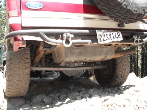 1991 Ford Bronco - Rear view of a 1991 Ford Bronco showing its axle, fuel tank, and aftermarket bumper.