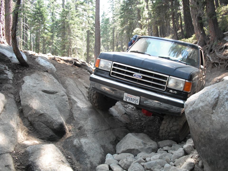Ford F-Series truck navigating a rocky trail