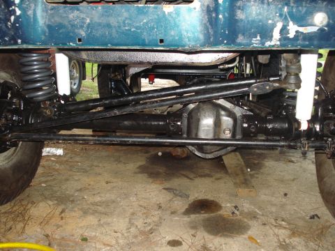 1978 Ford Bronco - Close-up of a vehicle's undercarriage, focusing on the suspension and drivetrain components.