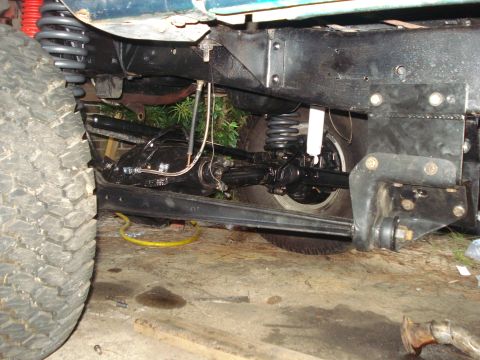 1978 Ford Bronco - Close-up view of the vehicle's undercarriage, highlighting suspension and drivetrain parts.