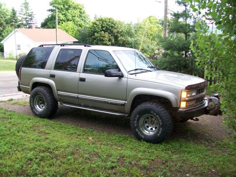 2000 Chevrolet Tahoe - This 1995 Chevrolet Tahoe SUV is shown from a 3/4 front angle, parked on a grassy area next to a house.