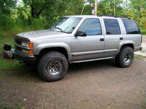 2000 Chevrolet Tahoe - Silver Chevrolet Tahoe with off-road tires and a winch on the front bumper.