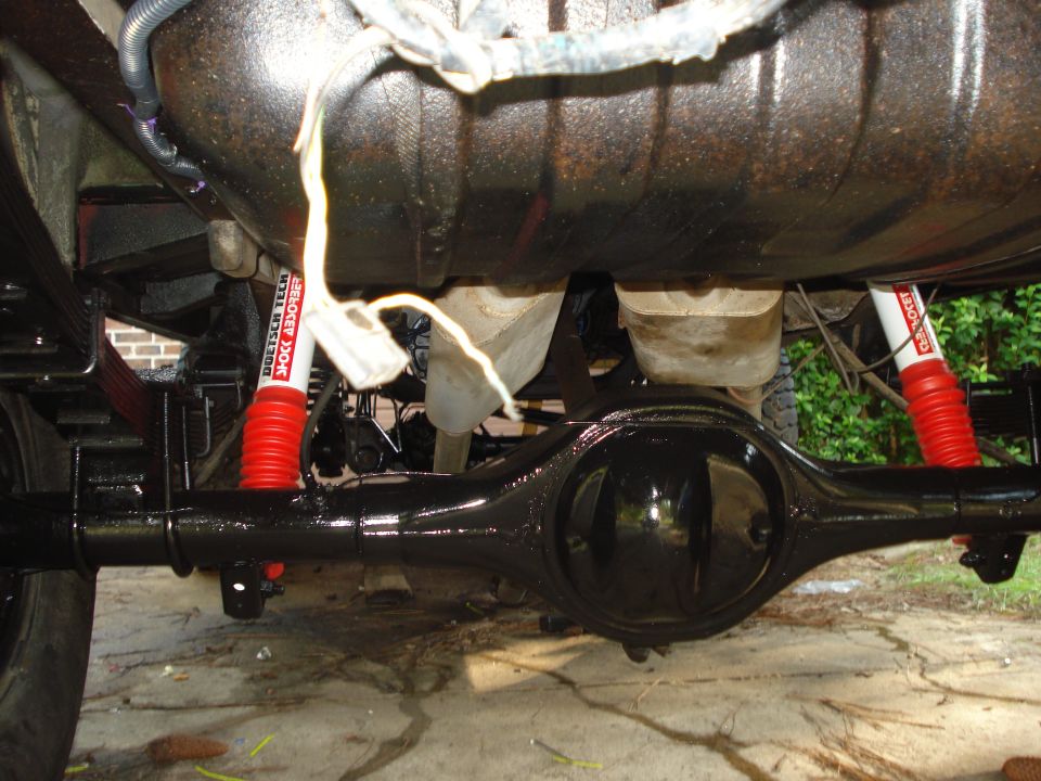 Rear differential and red shock absorbers with "Doetsch Tech" text